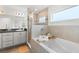 Bathroom featuring a bathtub, tiled shower, modern vanity, and a window providing natural light at 6708 162Nd E Pl, Parrish, FL 34219