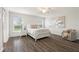 Bright bedroom featuring wood-look flooring, a ceiling fan, and neutral decor, offering a peaceful retreat at 6708 162Nd E Pl, Parrish, FL 34219