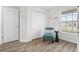 Well-lit bedroom featuring a chair, small table, window and closet at 6708 162Nd E Pl, Parrish, FL 34219