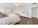 Cozy bedroom showcasing a bed with white linens, a matching dresser, and wood-look floors for a comfortable living space at 6708 162Nd E Pl, Parrish, FL 34219