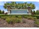 Community entrance sign with the name 'Aviary' in front of decorative bushes and palm trees at 6708 162Nd E Pl, Parrish, FL 34219