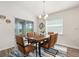 Dining room features a modern light fixture and a sliding glass door that provides natural light and access to the backyard at 6708 162Nd E Pl, Parrish, FL 34219