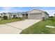 Exterior view of a home with a driveway, landscaped front yard, and well-manicured lawn at 6708 162Nd E Pl, Parrish, FL 34219