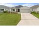 Charming single-story home with a well-manicured lawn and a two-car garage and neutral color scheme at 6708 162Nd E Pl, Parrish, FL 34219