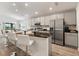 Stylish kitchen island with stainless steel appliances, granite countertops, and modern white barstools at 6708 162Nd E Pl, Parrish, FL 34219