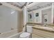 Cozy bathroom featuring a shower-tub combo and granite countertop vanity at 6713 Stone River Rd # 206, Bradenton, FL 34203