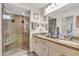 Bathroom featuring a large glass shower, double sinks, and granite countertops at 6713 Stone River Rd # 206, Bradenton, FL 34203