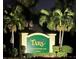 Night view of the Tara Golf & Country Club community entrance sign with palm trees at 6713 Stone River Rd # 206, Bradenton, FL 34203