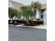 Charming condo exterior with lush landscaping including mature palm trees at 6713 Stone River Rd # 206, Bradenton, FL 34203