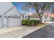 Condo exterior view showcasing garage and landscaped grounds at 6713 Stone River Rd # 206, Bradenton, FL 34203