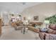 Inviting living room featuring neutral tones, vaulted ceilings, and an open layout to the kitchen at 6713 Stone River Rd # 206, Bradenton, FL 34203