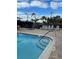 Relaxing pool with lounge chairs and lush tropical landscaping at 6713 Stone River Rd # 206, Bradenton, FL 34203