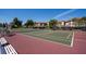 Outdoor tennis court with surrounding seating and residential buildings in the background at 6713 Stone River Rd # 206, Bradenton, FL 34203