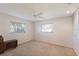 Bright bedroom featuring carpet, a ceiling fan, and two windows at 7204 18Th W Ave, Bradenton, FL 34209