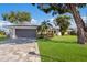 Charming single-story home boasts a well-manicured lawn, lush landscaping, and a paved driveway leading to a gray two-car garage at 7204 18Th W Ave, Bradenton, FL 34209