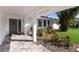 Inviting front porch with stone pavers and lush tropical landscaping leading to the front door at 7204 18Th W Ave, Bradenton, FL 34209