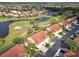 Aerial view showcases homes with golf course and lake views and meticulously manicured green fairways at 7232 Cedar Hollow Cir # 7232, Bradenton, FL 34203