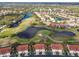 Aerial view displays property adjacent to the well-maintained golf course and lake, highlighting its desirable location at 7232 Cedar Hollow Cir # 7232, Bradenton, FL 34203