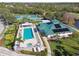 An aerial view of the community pool, clubhouse, and tennis courts at 7232 Cedar Hollow Cir # 7232, Bradenton, FL 34203