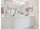 Bathroom featuring double sink vanity, tile floors, with a large well-lit mirror at 7232 Cedar Hollow Cir # 7232, Bradenton, FL 34203