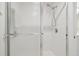 Bathroom stall with glass door, white tile, a shower head, and a silver handle at 7232 Cedar Hollow Cir # 7232, Bradenton, FL 34203