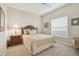 Comfortable bedroom boasts a ceiling fan, bedside table, and window with bright sunlight at 7232 Cedar Hollow Cir # 7232, Bradenton, FL 34203