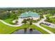 Exterior aerial view of the community clubhouse featuring lush landscaping and parking at 7232 Cedar Hollow Cir # 7232, Bradenton, FL 34203