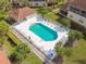 Aerial view of a community pool with lounge chairs, umbrellas, and a white fence surrounding the area at 7232 Cedar Hollow Cir # 7232, Bradenton, FL 34203