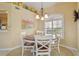 Charming dining area with a round wood table, white chairs, and decorative accents above at 7232 Cedar Hollow Cir # 7232, Bradenton, FL 34203