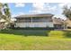 Back of home featuring a screened-in porch on the first floor and a large screened-in balcony above at 7232 Cedar Hollow Cir # 7232, Bradenton, FL 34203