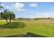 Beautiful view of the golf course with a pond under the blue sky at 7232 Cedar Hollow Cir # 7232, Bradenton, FL 34203