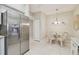 Kitchen featuring stainless steel refrigerator and an adjacent dining area at 7232 Cedar Hollow Cir # 7232, Bradenton, FL 34203