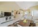 Bright living room with a high ceiling, neutral walls, and access to the dining area at 7232 Cedar Hollow Cir # 7232, Bradenton, FL 34203