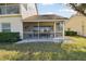 Screened-in patio area with table and chairs and white rock surround at 7232 Cedar Hollow Cir # 7232, Bradenton, FL 34203