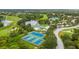 Overhead view featuring the community tennis courts, clubhouse, pool, and surrounding lake and golf course at 7232 Cedar Hollow Cir # 7232, Bradenton, FL 34203