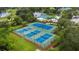 Aerial view of community tennis courts surrounded by well-maintained landscaping and grass at 7232 Cedar Hollow Cir # 7232, Bradenton, FL 34203