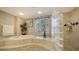 An elegant bathroom features a soaking tub, walk-in shower, and serene design at 7303 Westminster Ct, University Park, FL 34201