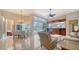 A bright dining room with chandelier, custom built-ins, and views of the screened in pool at 7303 Westminster Ct, University Park, FL 34201