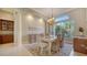 Formal dining room with elegant furniture, marble floors, and a decorative chandelier at 7303 Westminster Ct, University Park, FL 34201