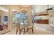 Bright dining area with views of the screened in pool, a chandelier, and custom wood cabinetry at 7303 Westminster Ct, University Park, FL 34201