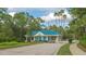 The community entrance gate featuring a charming design and lush landscaping for a welcoming arrival at 7303 Westminster Ct, University Park, FL 34201