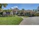 Charming one-story home with manicured lawn, elegant walkway, and lush tropical landscaping at 7303 Westminster Ct, University Park, FL 34201