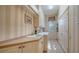 Bright laundry room with a sink, countertop space, cabinets, and a closet for extra storage at 7303 Westminster Ct, University Park, FL 34201