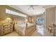 This is the main bedroom suite with decorative lamps, side tables, and large bright windows at 7303 Westminster Ct, University Park, FL 34201