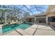 Inviting screened-in pool area with a spa and view of the outdoors, creating a relaxing outdoor oasis at 7303 Westminster Ct, University Park, FL 34201