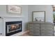 Bedroom detail of a fireplace and a dresser with a mirror, enhancing the room's cozy feel at 7608 Teal Trce, Bradenton, FL 34203