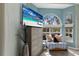 Bedroom sitting area with window view, TV on dresser and modern interior design elements at 7608 Teal Trce, Bradenton, FL 34203