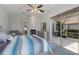 Bedroom with fireplace, dresser and mirror leading to a outdoor patio through sliding glass doors at 7608 Teal Trce, Bradenton, FL 34203