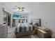 Bright bedroom featuring a ceiling fan, TV, and sliding glass doors to a private outdoor space at 7608 Teal Trce, Bradenton, FL 34203