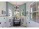 Bright breakfast nook featuring arched windows, decorative chandelier, and tiled walls at 7608 Teal Trce, Bradenton, FL 34203